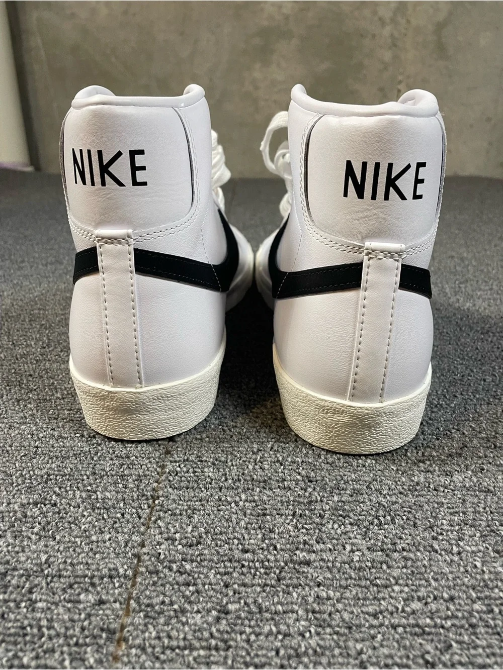Men’s Nike White High-Top Sneakers with Black Swoosh
